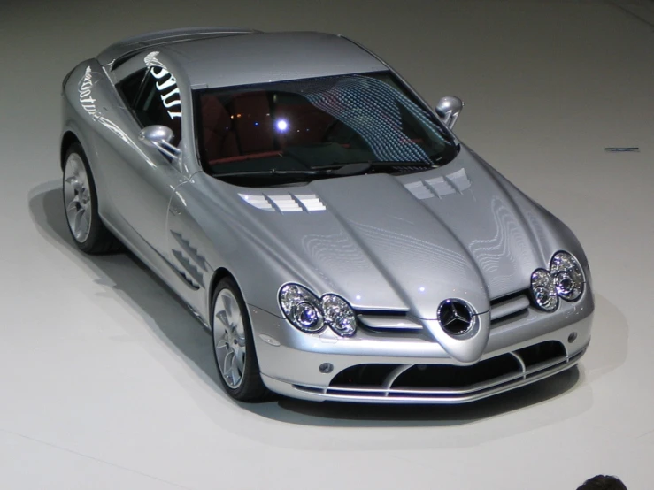 a car on a display with a person standing behind