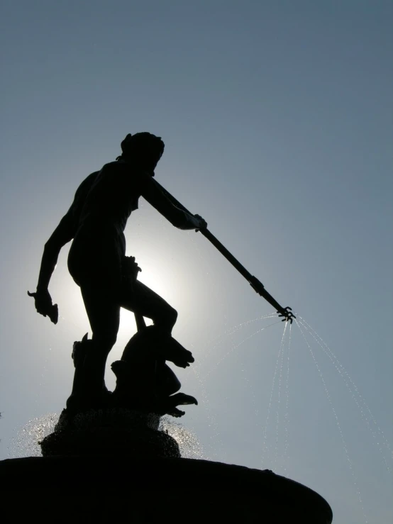 a statue with a man standing on top of it