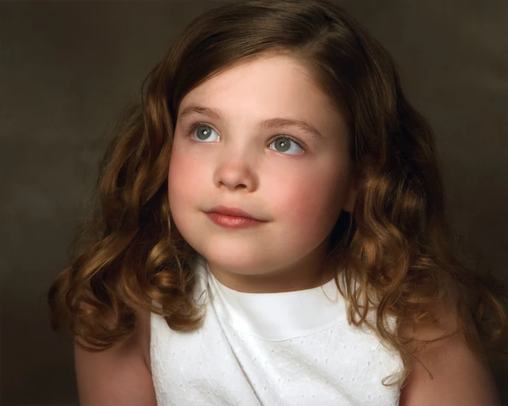 a little girl looking straight ahead in this studio po