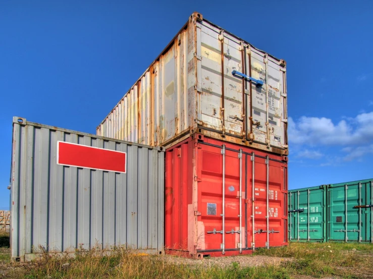 a big pile of containers are next to some green and red