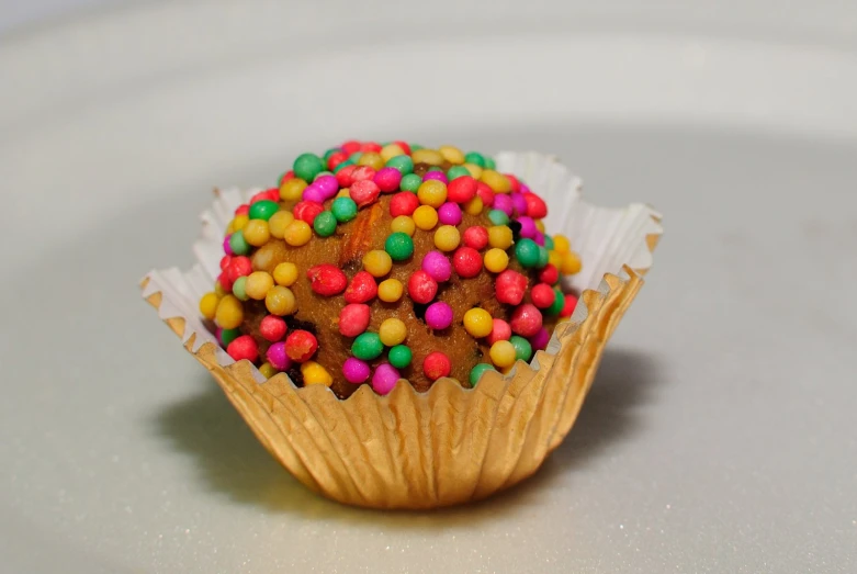 this is some kind of candy that is decorated with multi colored sprinkles