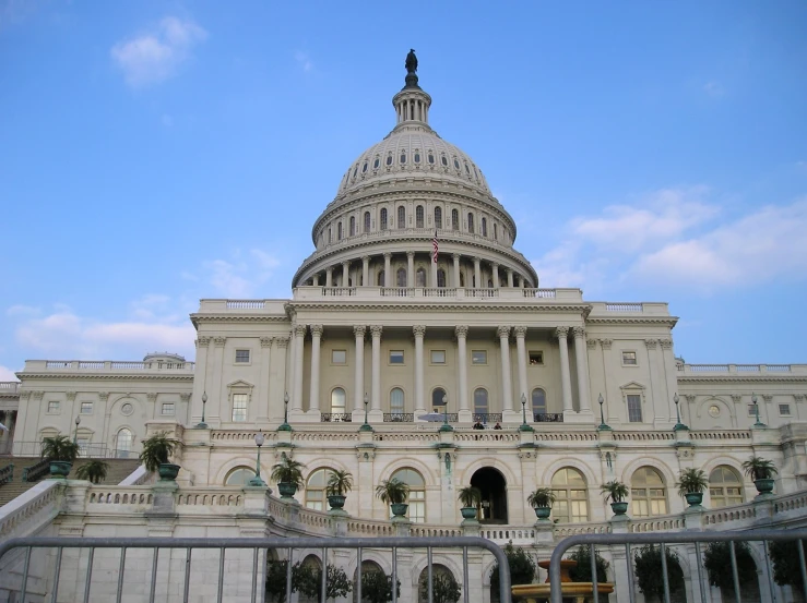 the u s capitol building is seen from across the street