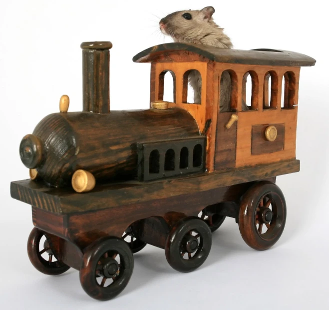 a toy train is shown with a mouse on top