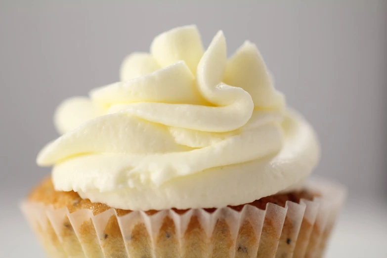 there is a cupcake topped with vanilla frosting