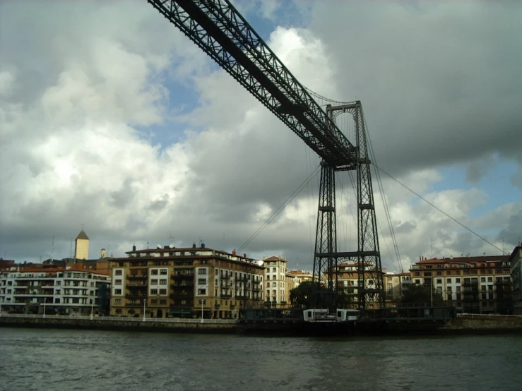 a large metal bridge spans over a city