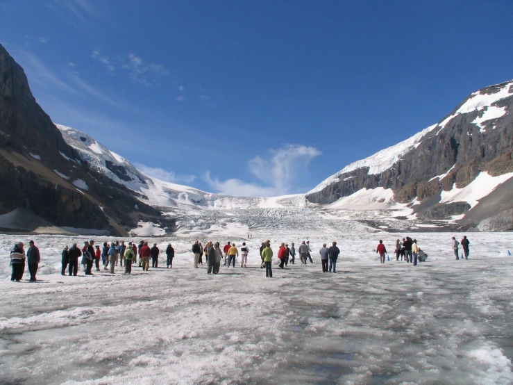 a large group of people standing on a snowy surface