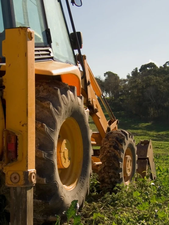 the tractor is driving through the lush green field