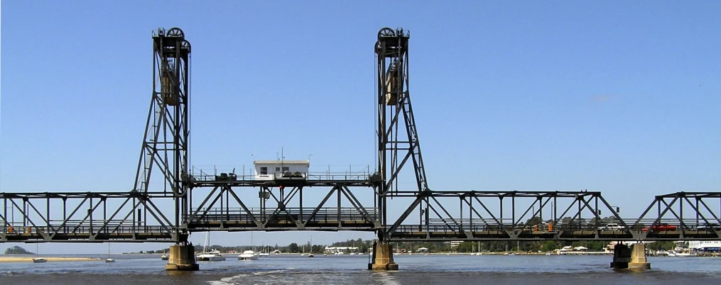 the bridge is being lifted to let boats on the water below it