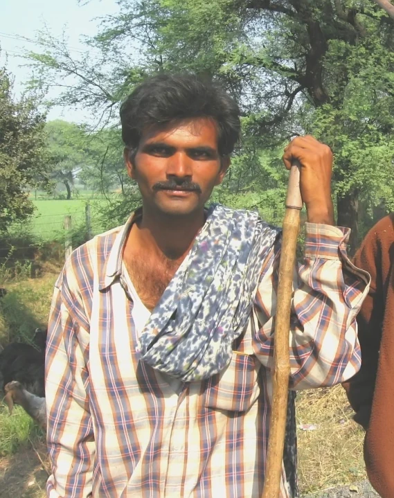 two men in a field with some trees