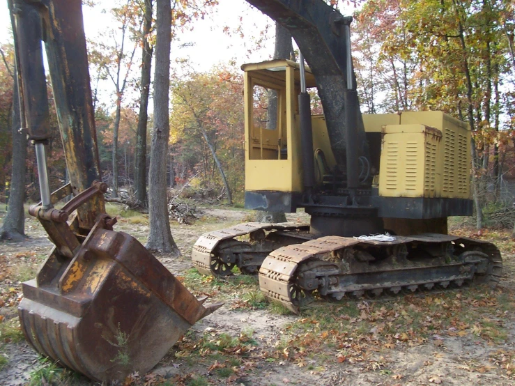 there is an old bulldozer sitting in the field