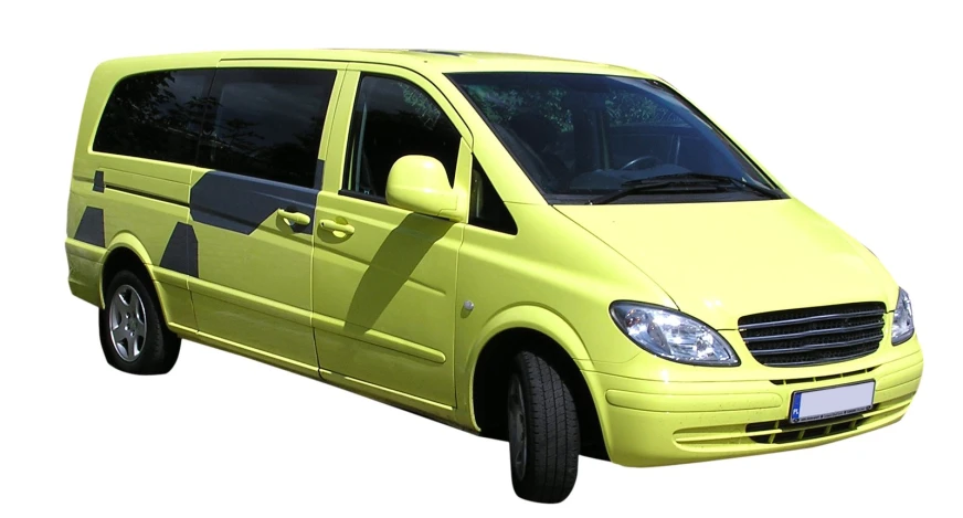 a yellow van with a black stripe driving on the road