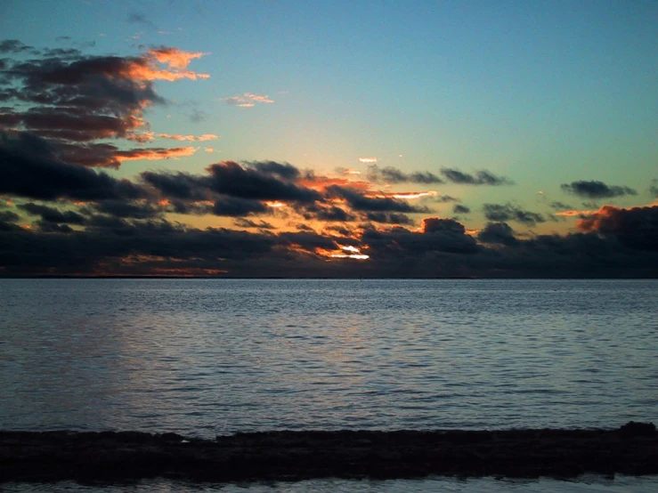 a view of the sun setting over the ocean