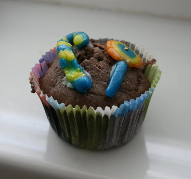 a chocolate cupcake with icing and chocolate decorations