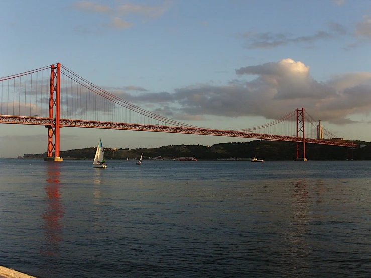 a boat on the water and a bridge in the distance