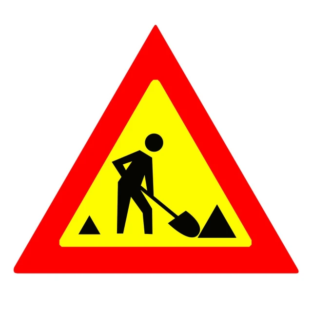a caution triangle sign is on a white background