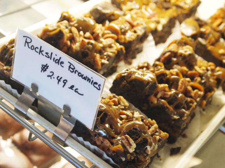 some brownies are on a rack with some paper