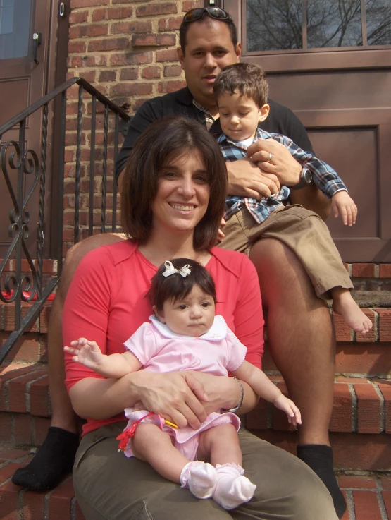 a man and woman are sitting with their daughter