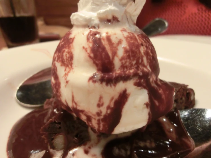 a dessert with chocolate ding, ice cream and drizzle of chocolate sauce