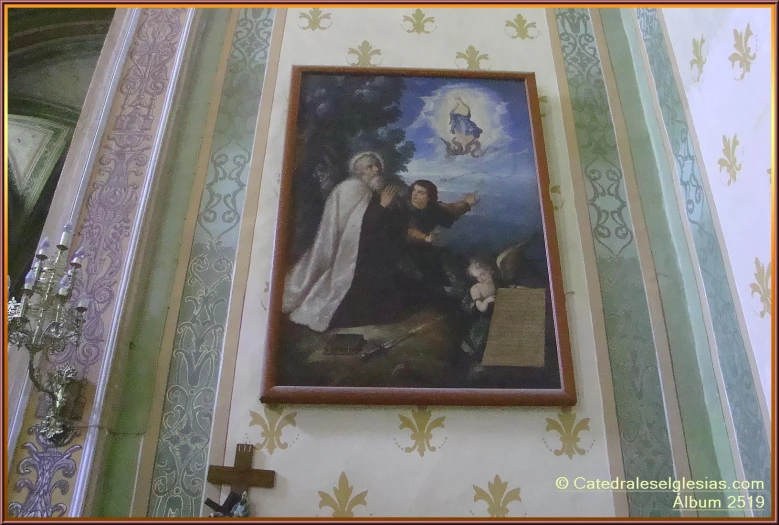 a picture hanging on a wall with a cross