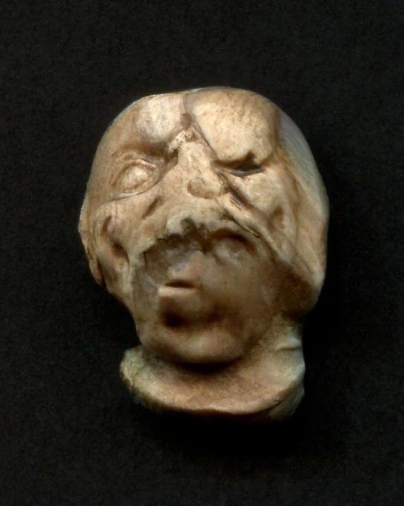 a sculpture depicting an old man with its face open