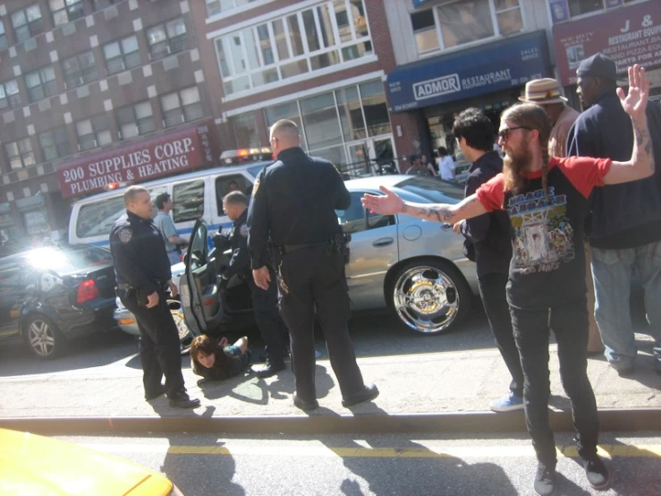 a group of men talking to each other on a street