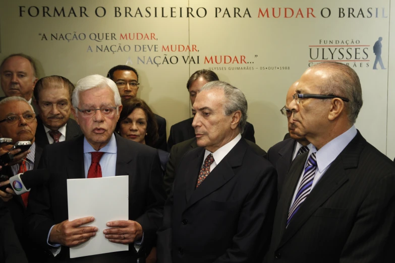 four men dressed in business attire standing next to each other