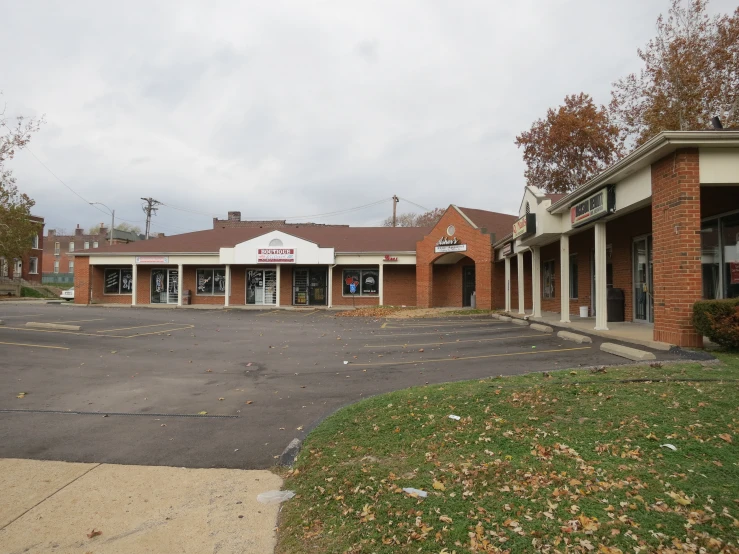 an empty parking lot next to a building with many parking spaces