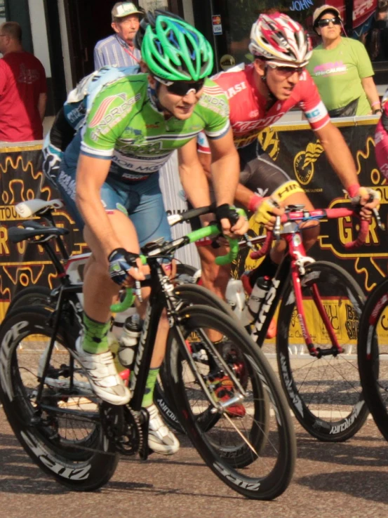 a couple of cyclists racing across a street