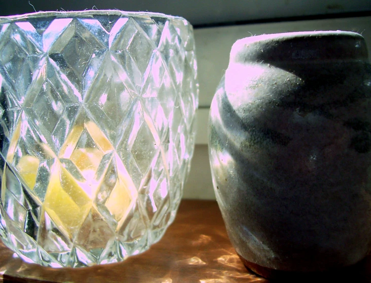 two vases that are sitting on top of a table