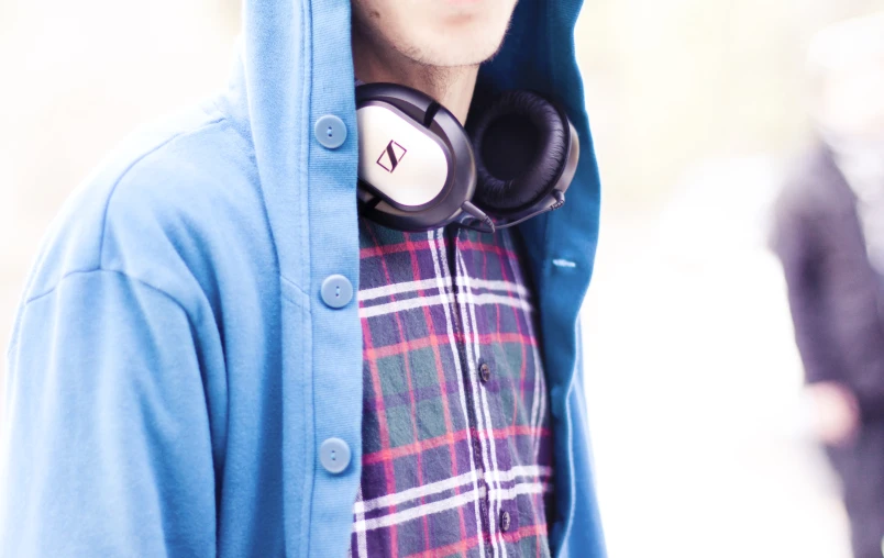 a man wearing headphones while standing outside