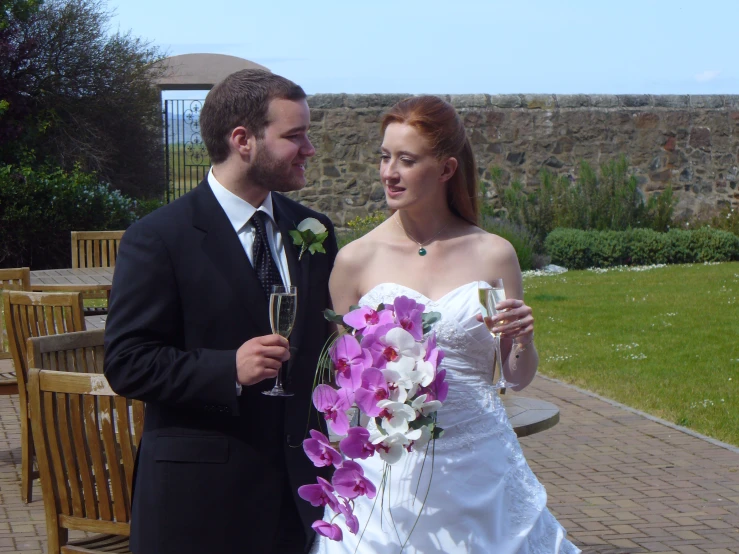 the bride and groom smile as they stand beside each other