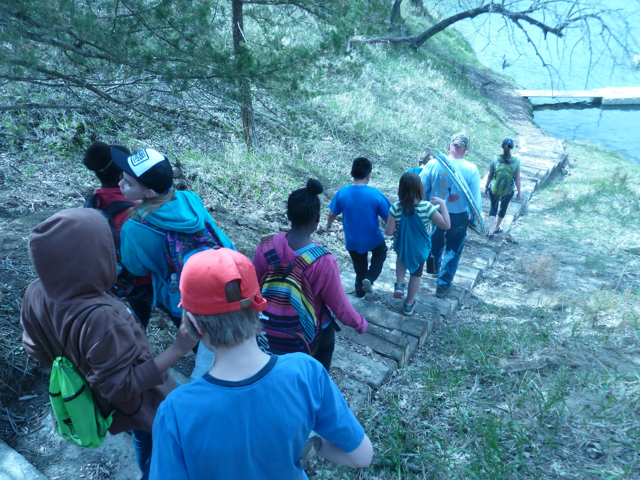 a group of people on stairs and walking beside water