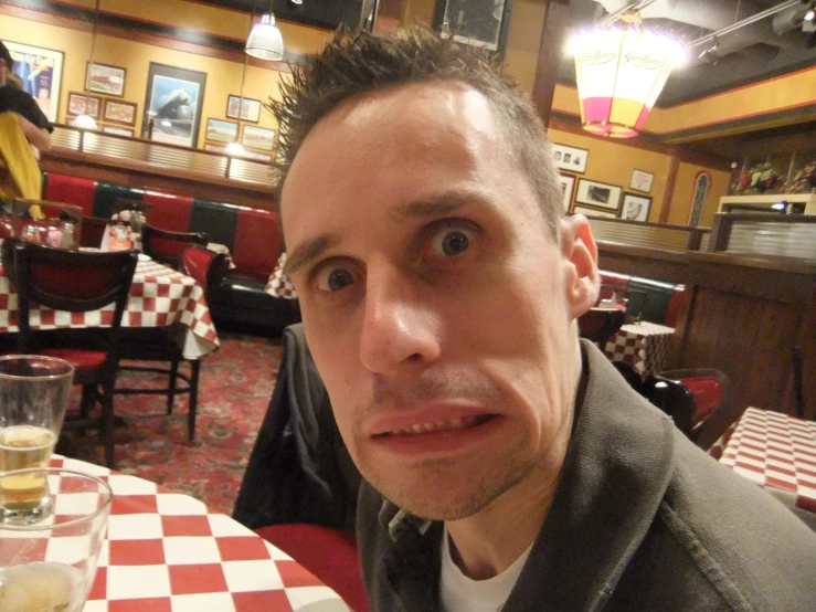 a man sitting at a table with glasses in front of him