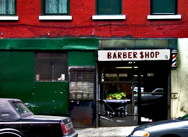 a car parked in front of a barber shop