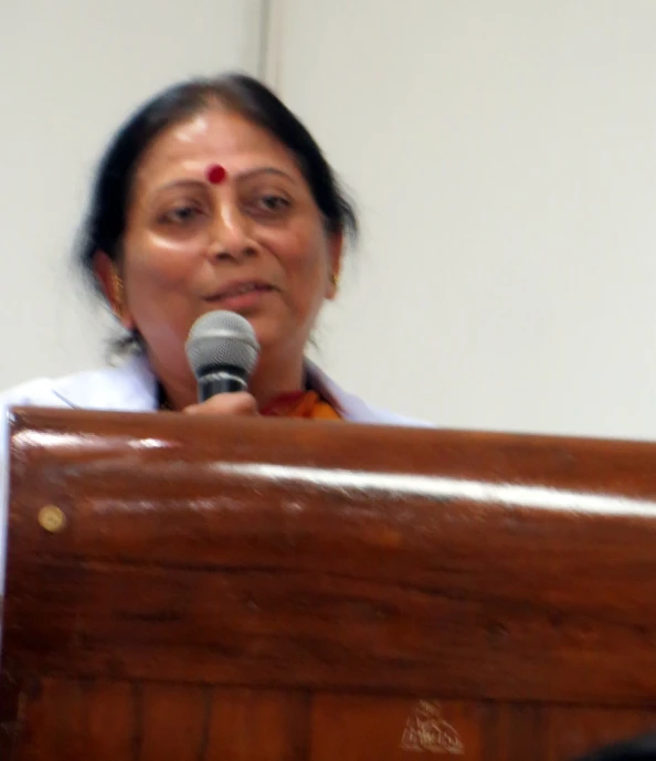 a woman in sari and a microphone