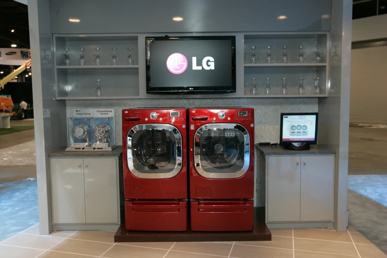 a commercial laundry washer and dryer are displayed for public use