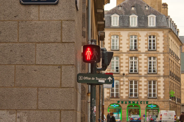 a traffic light is next to a brick wall