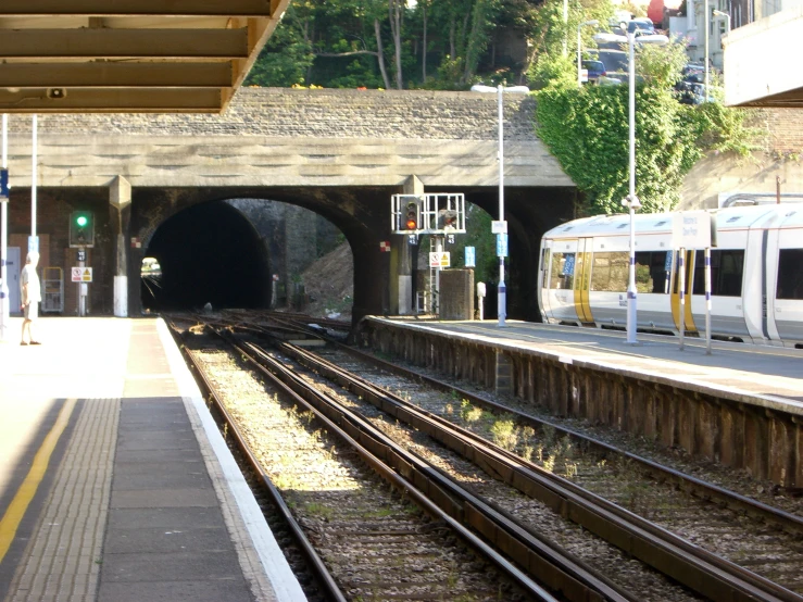 a train sitting at the side of a subway platform