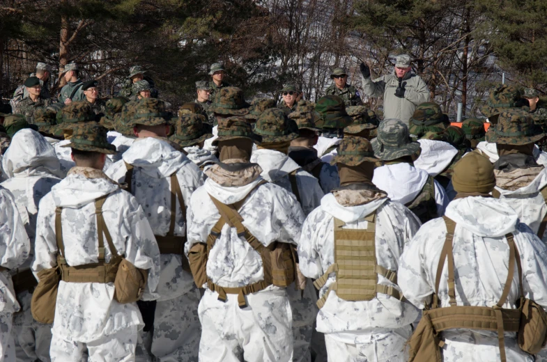 the men are in military camouflage and fatigues