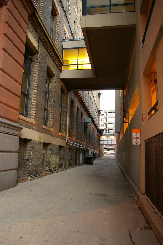 an empty street between buildings next to each other