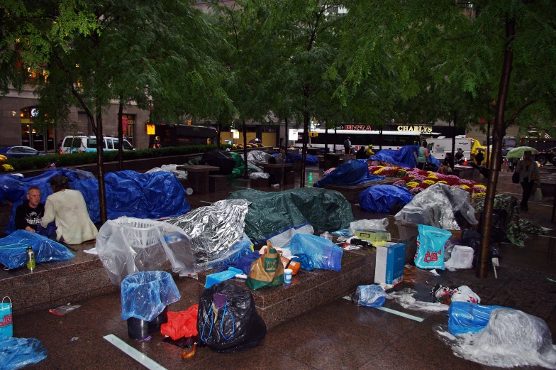 people sitting around a lot filled with bags