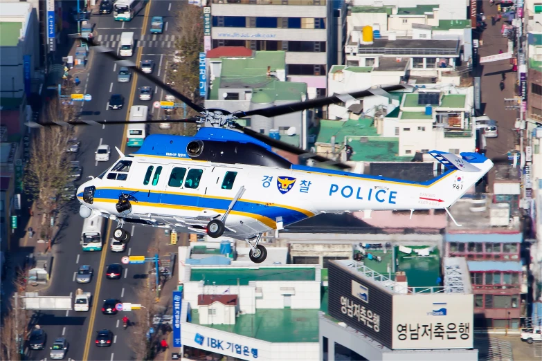 an emergency helicopter is flying over the city