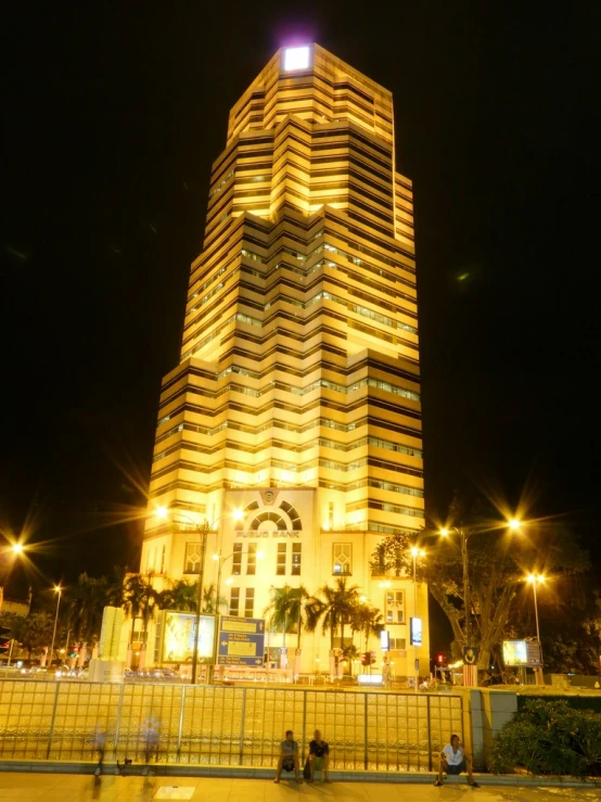 a tall building with lights shine on the facade