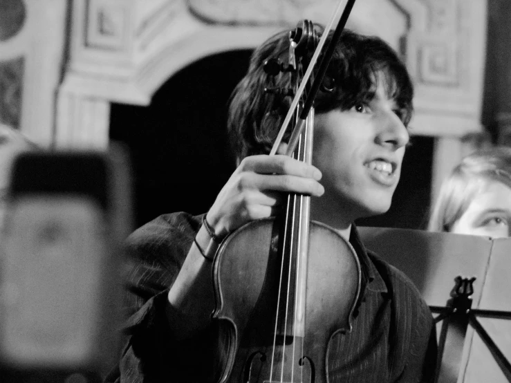 a girl is playing a violin on the stage