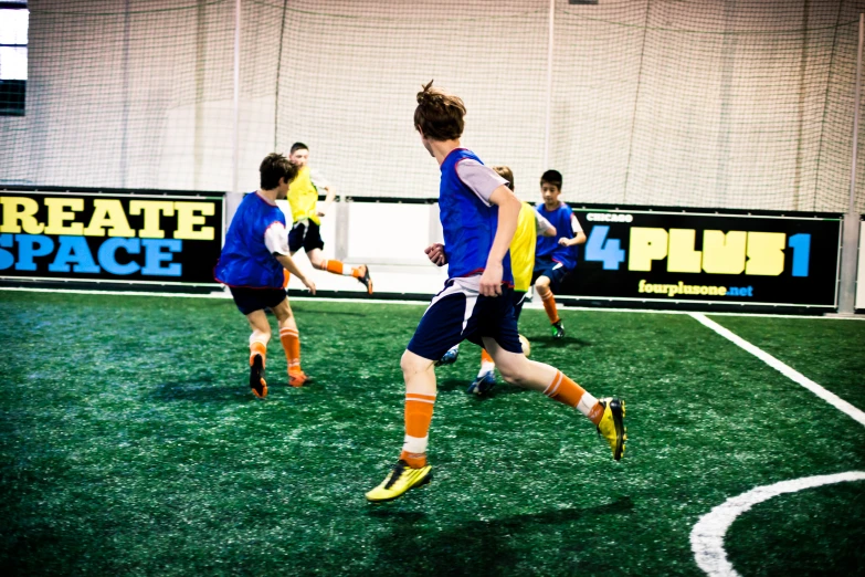 a group of young people kicking around a soccer ball