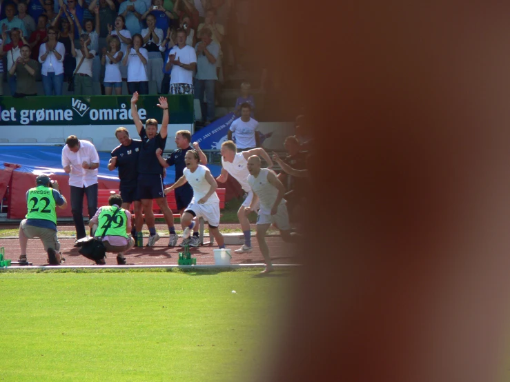 a group of people running on the field at an event