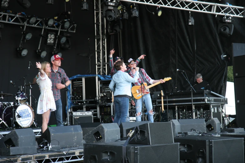 a band playing on stage and some other people waving