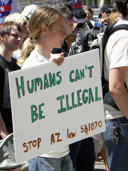 a person holding a sign in a group