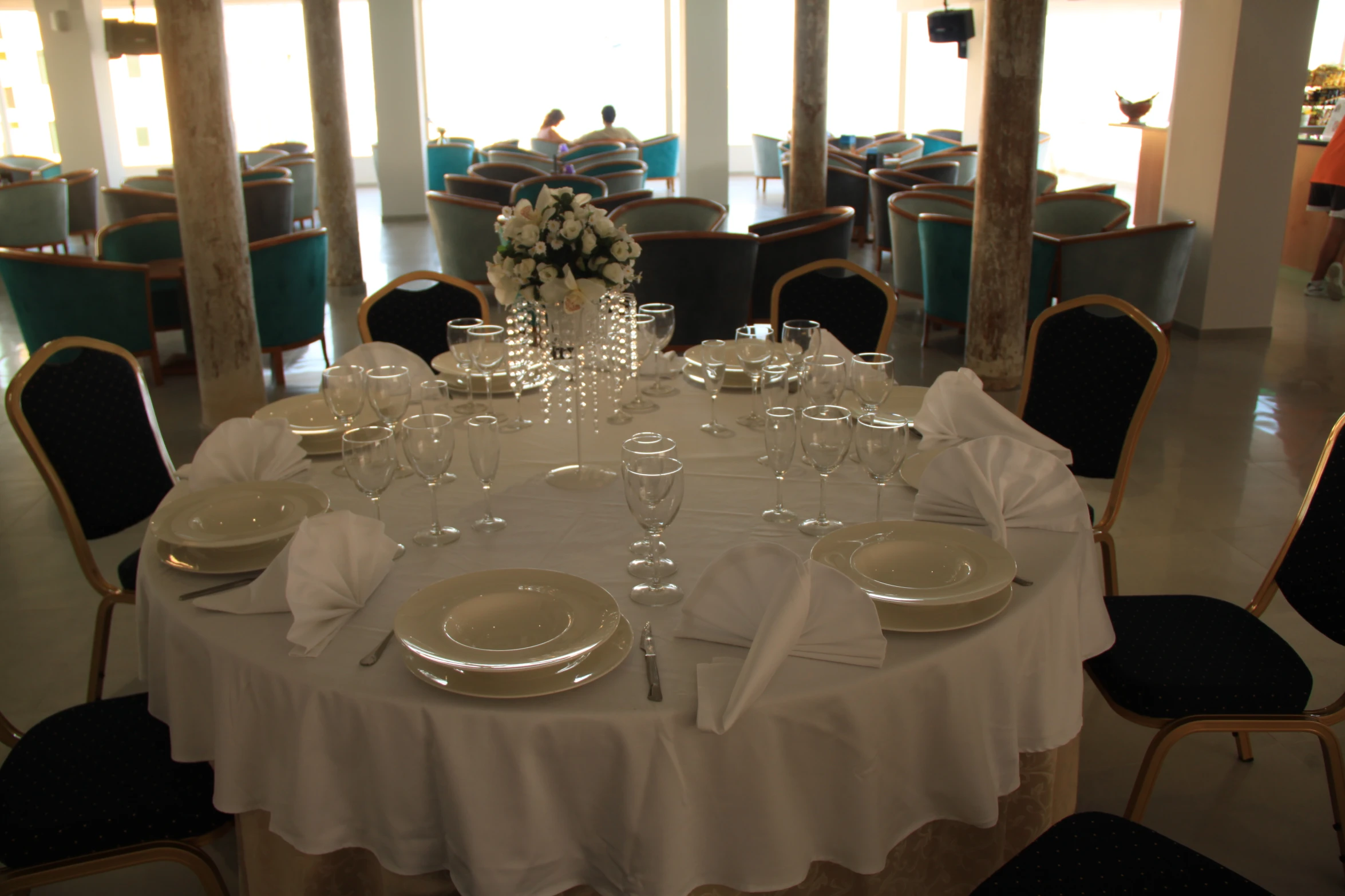 a round table covered in white plates and silverware