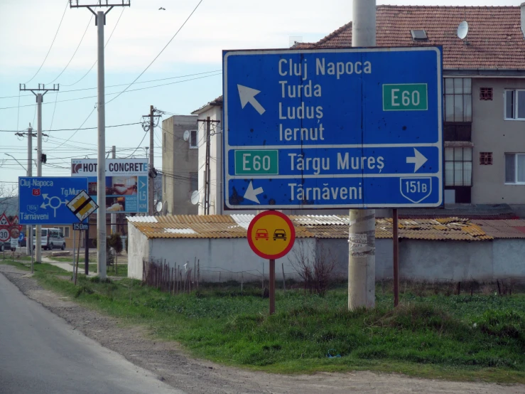 a highway sign next to a road with buildings on it